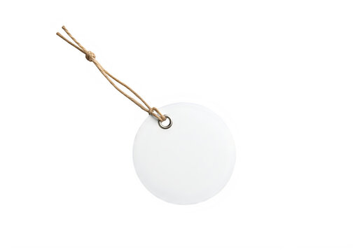 Round white paper tag with brown string and metal eyelet isolated on a transparent background