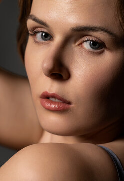 Young woman's face, lips, and eyes with perfect skin texture and natural makeup