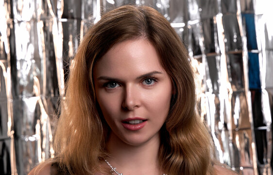 Woman looking directly at camera, capturing a glamorous moment at a party