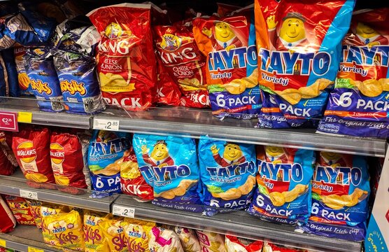 packets of crisps on a shelf at the supermarket