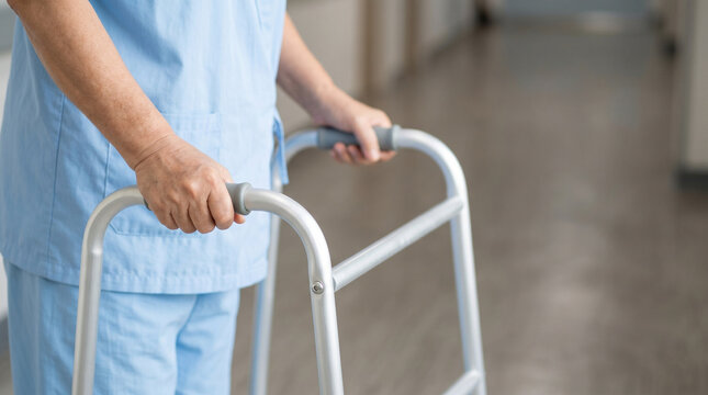 elderly person using walker for senior care mobility support fall prevention and rehabilitation concept