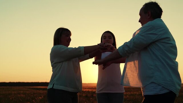 Business people raising their hands, team success group unity. Teamwork, business. Partners raise hands in gesture cooperation, achieving team goal result. People united by common idea. Outdoors, sky