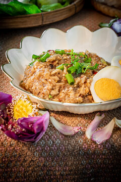 Healthy Thai pounded eggplant salad with boiled egg and herbs. Known as Tam Ma Khua in Northern Thailand or Soup Ma Khua in Isan, representing authentic regional Asian rustic home-cooked dining.