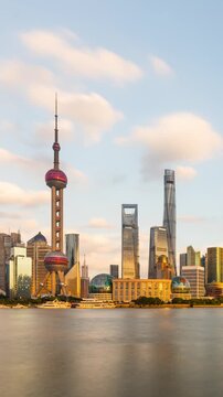 Time Lapse of clouds behind the tall buildings of the Shanghai China skyline. Vertical Video.