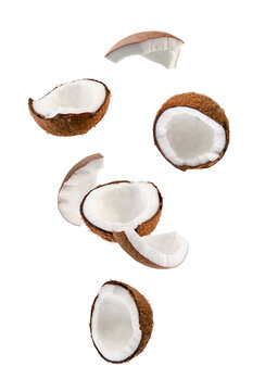 Perfectly retouched coconut halves and slices fall into space.
