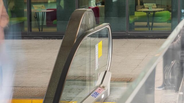 Timelapse of people riding escalator in subway or underground passage with continuous commuter flow, motion blur capturing urban transportation and daily city movement