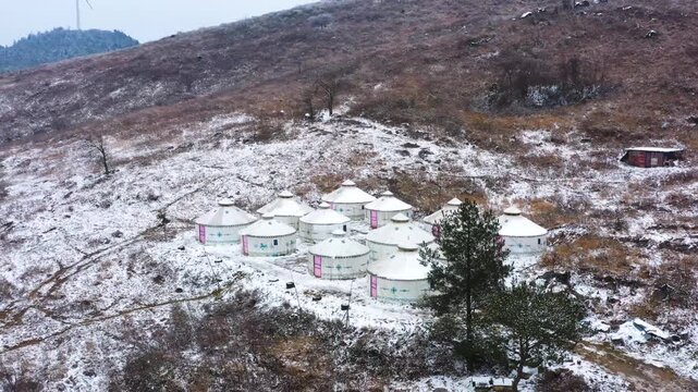 Snow Covered Yurt Camp on Remote Mountain Hillside