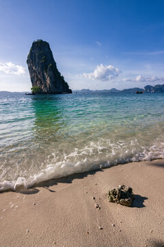 The limestone islet of Ko Ma Tang Ming from the white sand shore of Ko Poda beach in Krabi, Thailand