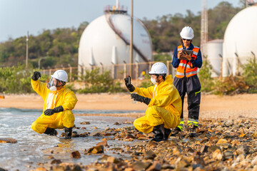 Corporate ESG and CSR sustainability: Hazmat scientists and ecologist testing toxic ocean water pollution near petrochemical refinery storage tanks for industrial environmental hazard control. © VStudio