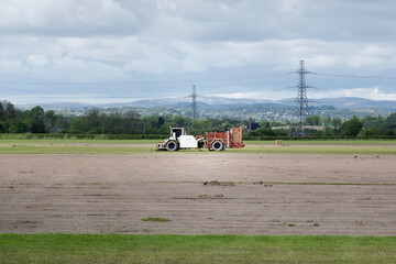 Fototapeta premium Combine harvester harvesting crops in Scotland