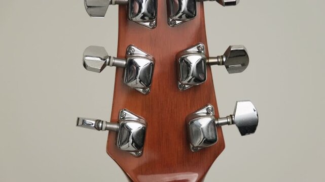 Guitar headstock with chrome tuning machine heads