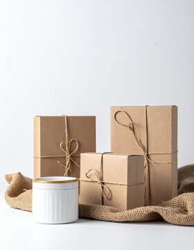 Three brown packages tied with twine, with white vase