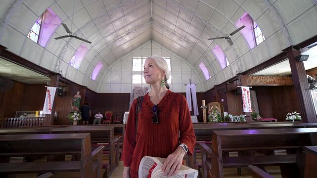 Mature woman visits Santa Barbara church in Santa Rosalia in Baja California Sur Mexico. She explores local sights, appreciating the culture and architecture