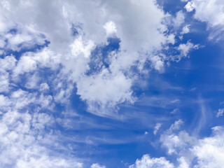 Fototapeta premium Bright blue sky with white fluffy clouds on a sunny day for weather background