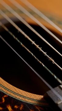 Close up guitar strings with warm sunlit bokeh