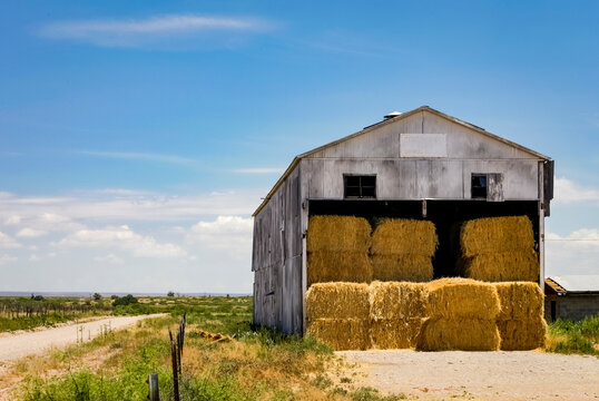Hay bales stacked inside a rural barn