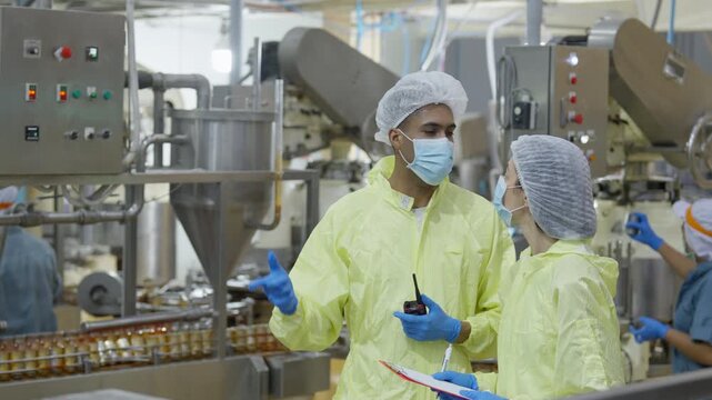 Food factory automated production line, Industrial factory food processing worker protective clothing mask hairnet clipboard quality control machinery production line teamwork, food production