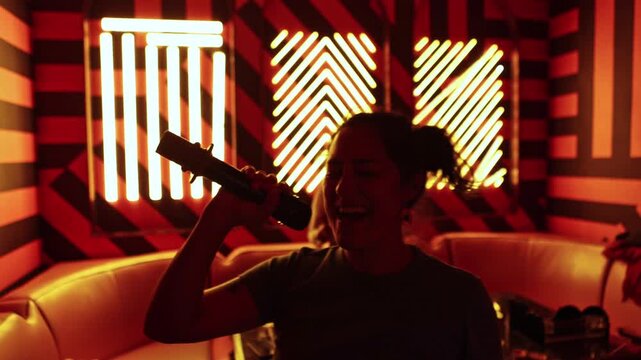 Cheerful woman singing karaoke with friends at a party