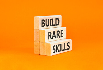 Naklejka premium Build rare skills words symbol. Concept words Build rare skills on beautiful wooden blocks. Beautiful orange background. Business and build rare skills concept. Copy space.