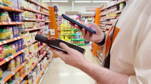 Young man shopping in supermarket, reading product information	