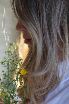 Woman holding Flowers close up. Seasonal Allergy and Spring Bloom Concept