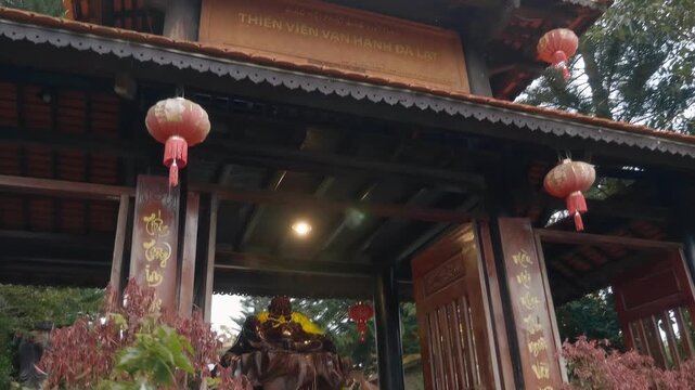 A massive wooden statue of Tran Vu deity known as the Emperor of the North stands in the garden of Thiền viện Vạn Hạnh - a renowned Zen Buddhist temple and a popular pilgrimage site and tourist 