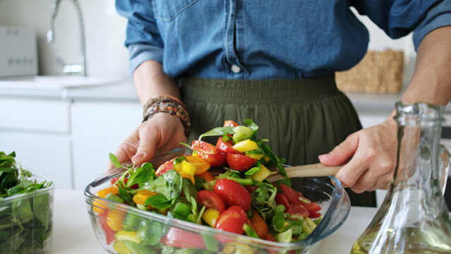 Woman Mixing Vegetable Salad