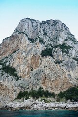 Fototapeta premium Towering rocks coastline of Capri island in Italy