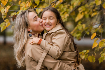 Fototapeta premium mother and daughter walking in the park in autumn
