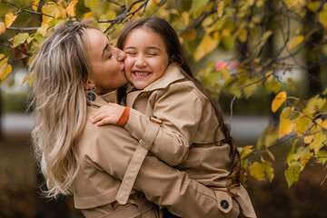Fototapeta premium mother and daughter walking in the park in autumn