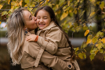 Fototapeta premium mother and daughter walking in the park in autumn