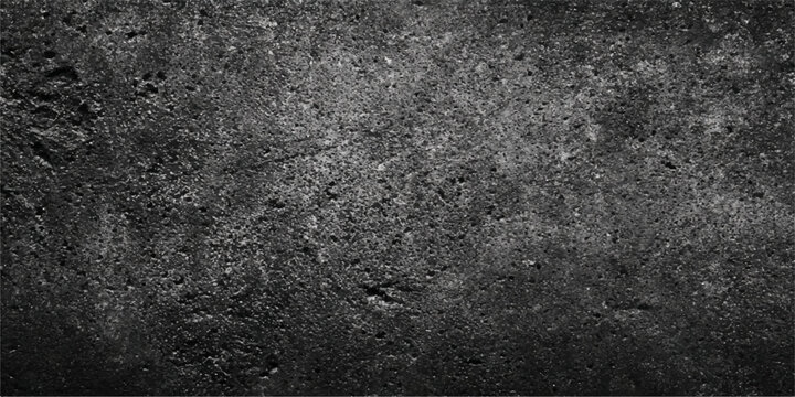 A dark gray grunge concrete wall with a rough black asphalt texture and a dirty aged stone pattern makes a perfect vintage material backdrop