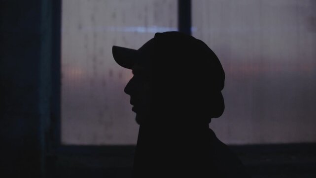 Dangerous Man in the Cap is walking quickly through the strret. Hideout Place has Dark Atmosphere. Shot on Arri Alexa Mini Camera.