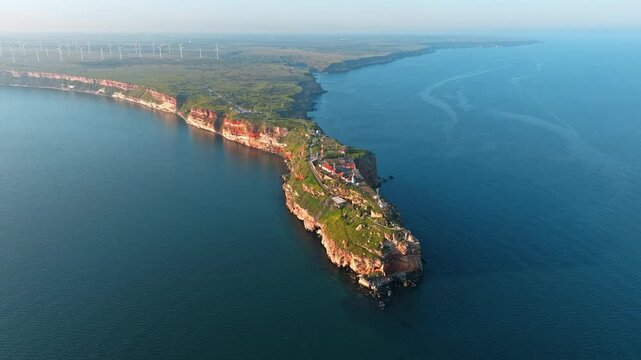 Kaliakra Cape Peninsula Black Sea Bulgaria Drone Aerial High Angle Red Cliffs Wind Turbines Spring Golden Hour Sunset Travel Tourism Nature Landmark Heritage Exploration Concept Video