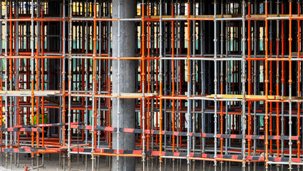 Concrete pillar stands firm amidst steel scaffolding © I