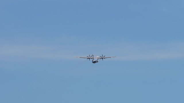 Turboprop passenger airplane taking off from runway at Phuket International Airport in Thailand.