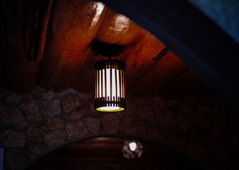 Warm Rustic Hanging Lamp Under Wooden Ceiling © Cherish