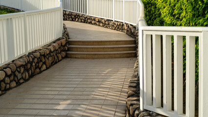 White railings flank stone-lined steps © I