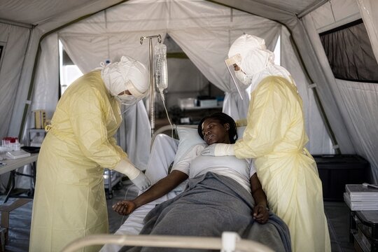 Dedicated medics offer life sustaining comfort in a field hospital during an epidemic