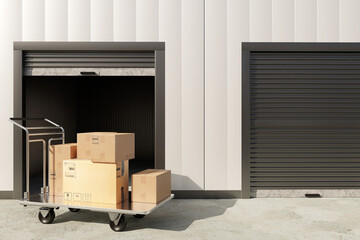 Self storage facility provides rental warehouse units with moving cart and cardboard boxes for relocation and secure personal storage © Grispb