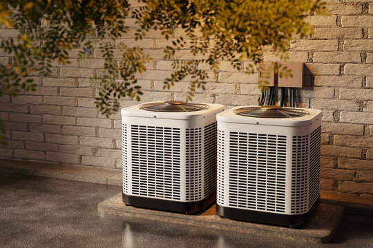 Residential outdoor air conditioning condenser units beside a brick house wall, home HVAC cooling and heating system installation