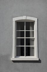 Fototapeta premium Portrait of white window on gray wall background 