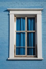 Fototapeta premium Portrait of white window on blue wall background 
