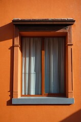 Obraz premium Portrait of colorful window on orange wall background 