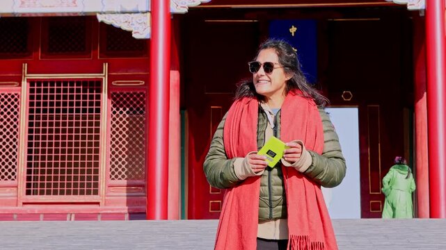 Woman with an audio guide enjoying the Forbidden City in Beijing