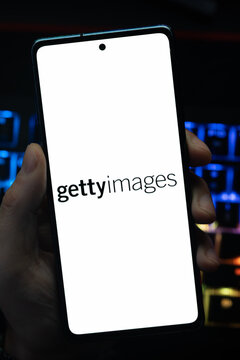 Punta Arenas, Chile &ndash; May 18, 2026: A person holding a smartphone displaying the Getty Images logo on its screen, with a blurry blue backlit keyboard in the background