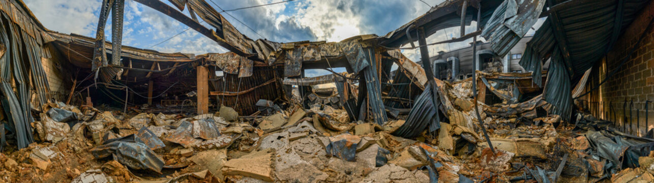 Wide panoramic shot of exterior building collapse after disaster.