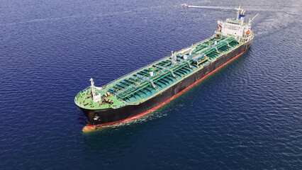 Aerial drone photo of crude Oil tanker ship underway towards open sea, a merchant ship specially...