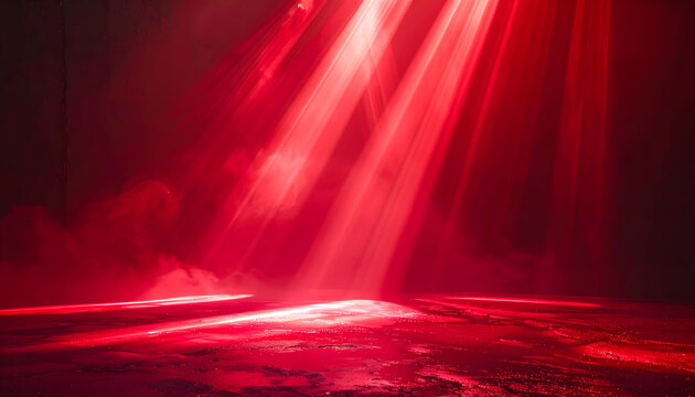 Bright scarlet beams shine with glossy reflections and soft haze in a dark room.
