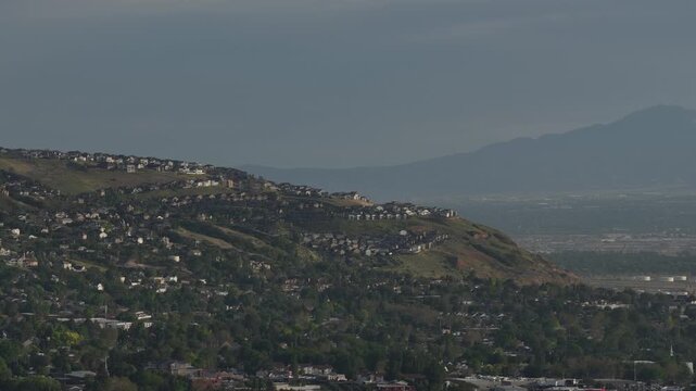 Aerial close up of hillside homes in Bountiful Utah at sunset with Wasatch Range